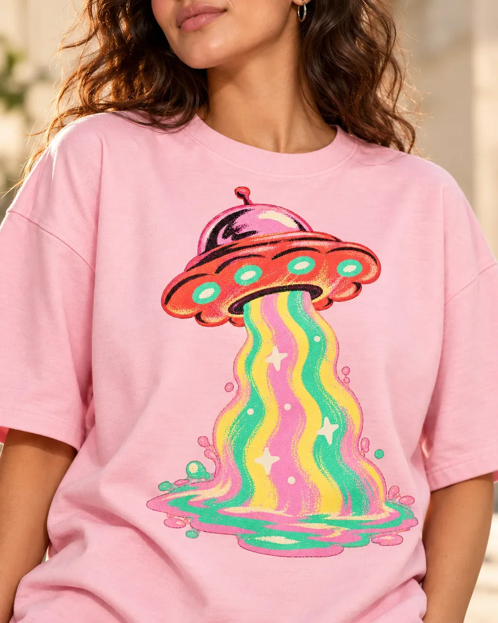 Angled close-up of the Strawberry Signal UFO print on a light baby pink French terry tee