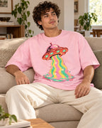 Man relaxing on a couch in the Strawberry Signal UFO oversized tee, light baby pink