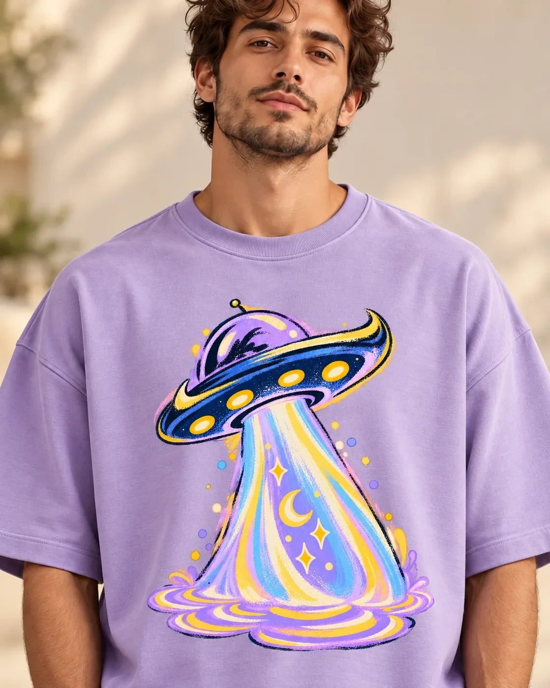 Moonbeam Club print close-up: navy-and-gold saucer with a pastel beam of crescent moons and stars on lavender French terry