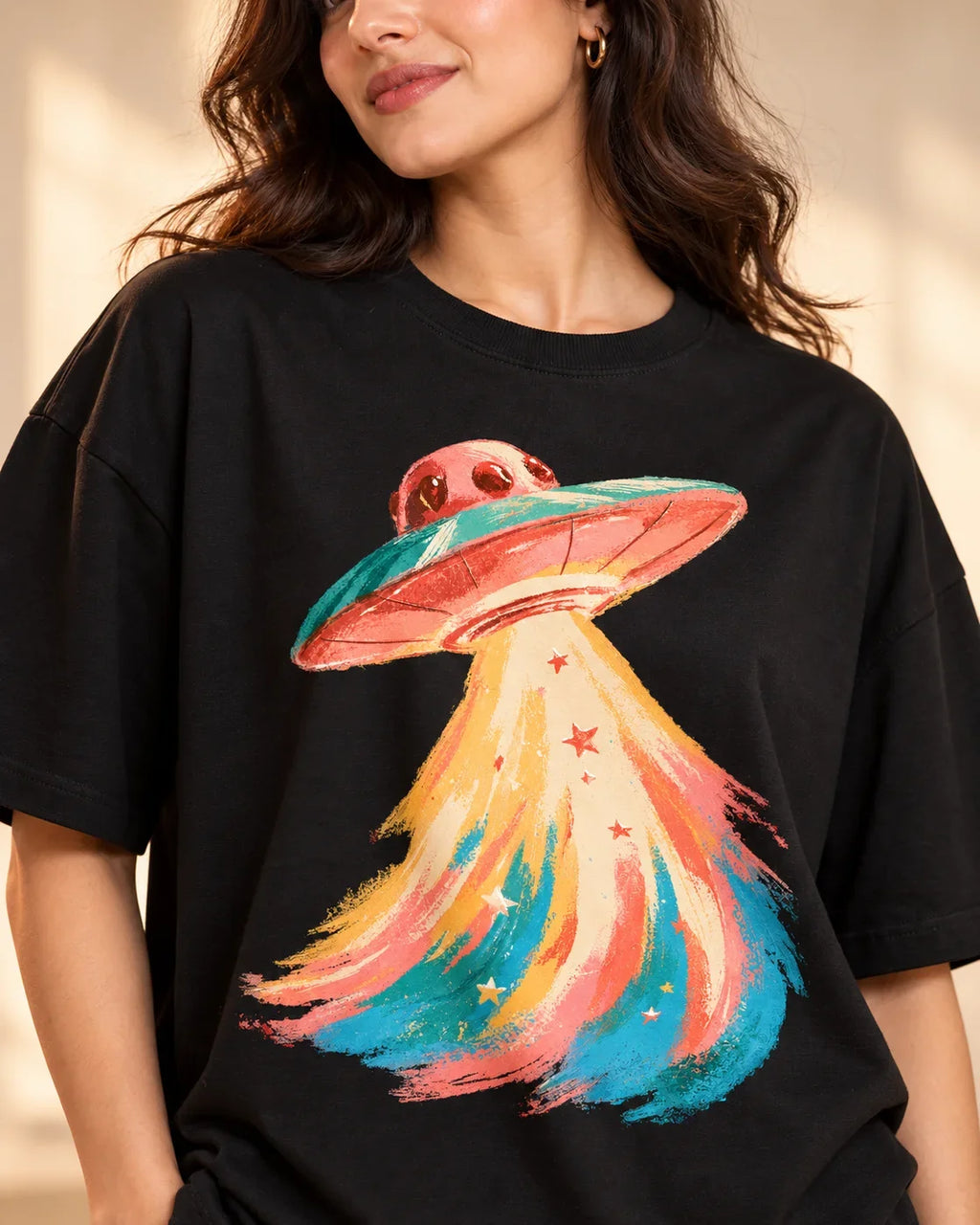 Angled close-up of the Peach Mirage UFO print on a black French terry tee