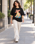 Woman walking down a city street in the Peach Mirage black French terry oversized tee