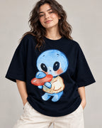 Woman in a navy blue oversized French terry t-shirt printed with a blue alien in a sweater hugging a small red UFO