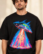 Hyperdrive Signal print close-up: sleek saucer in electric-blue speed streaks over a hot-pink beam on black French terry