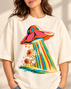 Cosmic Garden print close-up: coral saucer beaming rainbow stripes over orange daisies on off-white French terry