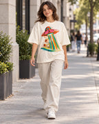 Woman walking down a city street in the Cosmic Garden off-white French terry oversized tee