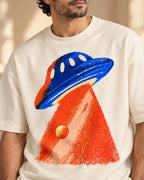 Angled close-up of the Cobalt Ember UFO print on an off-white French terry tee