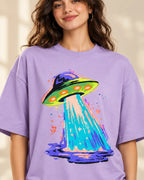 Electric Lagoon print close-up: purple-and-lime saucer splashing a turquoise beam into a purple pool on lavender French terry