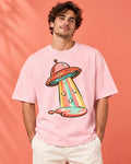 Model wearing the Candy Orbit UFO oversized tee in light baby pink – Fourth Dimension Club