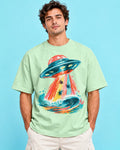 Model wearing the Tidal Transit UFO oversized tee in jade – Fourth Dimension Club