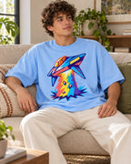 Man relaxing on a couch in the Prism Strike UFO oversized tee, baby blue