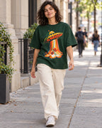 Woman walking down a city street in the Solar Petals bottle green French terry oversized tee