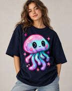 Woman in a navy blue oversized French terry t-shirt printed with a pastel jellyfish with starry eyes and pink sparkles