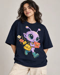 Woman in a navy blue oversized French terry t-shirt printed with a lilac alien with a yellow satchel delivering letters