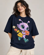 Woman in a navy blue oversized French terry t-shirt printed with a lilac alien with a yellow satchel delivering letters