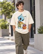 Man on a street in an off-white oversized French terry t-shirt with a blue alien watering a cactus in a meteor-like pot