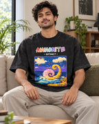 Model wearing the Ammonite black acid wash oversized T-shirt seated on a sofa, Fourth Dimension Club