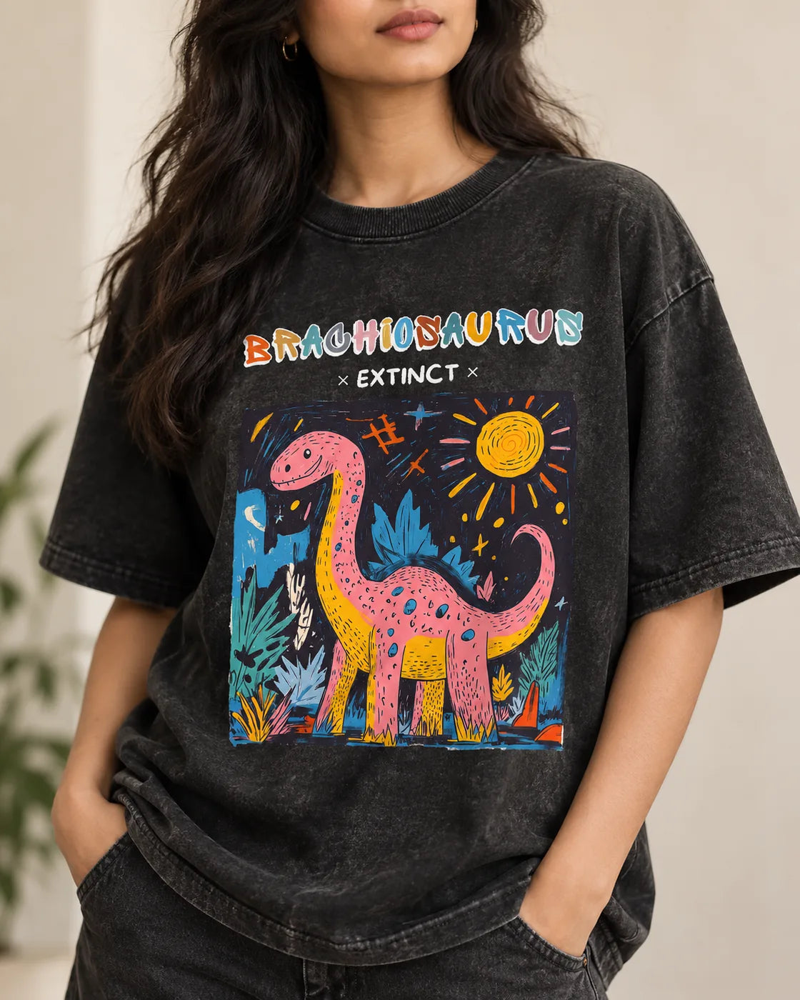 Close-up of the Brachiosaurus Ancient Archives print on a black acid wash oversized T-shirt