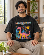 Model wearing the Brachiosaurus black acid wash oversized T-shirt seated on a sofa, Fourth Dimension Club