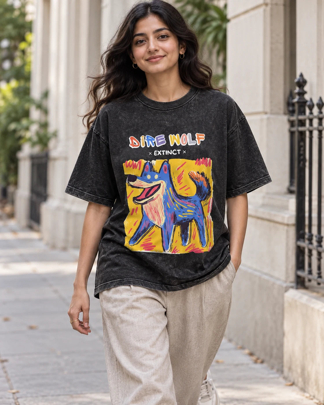Model wearing the Dire Wolf black acid wash oversized T-shirt on a city street, Fourth Dimension Club