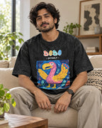 Model wearing the Dodo black acid wash oversized T-shirt seated on a sofa, Fourth Dimension Club