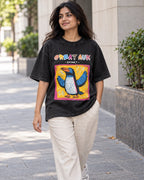 Model wearing the Great Auk black acid wash oversized T-shirt on a city street, Fourth Dimension Club