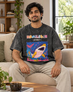 Model wearing the Megalodon black acid wash oversized T-shirt seated on a sofa, Fourth Dimension Club