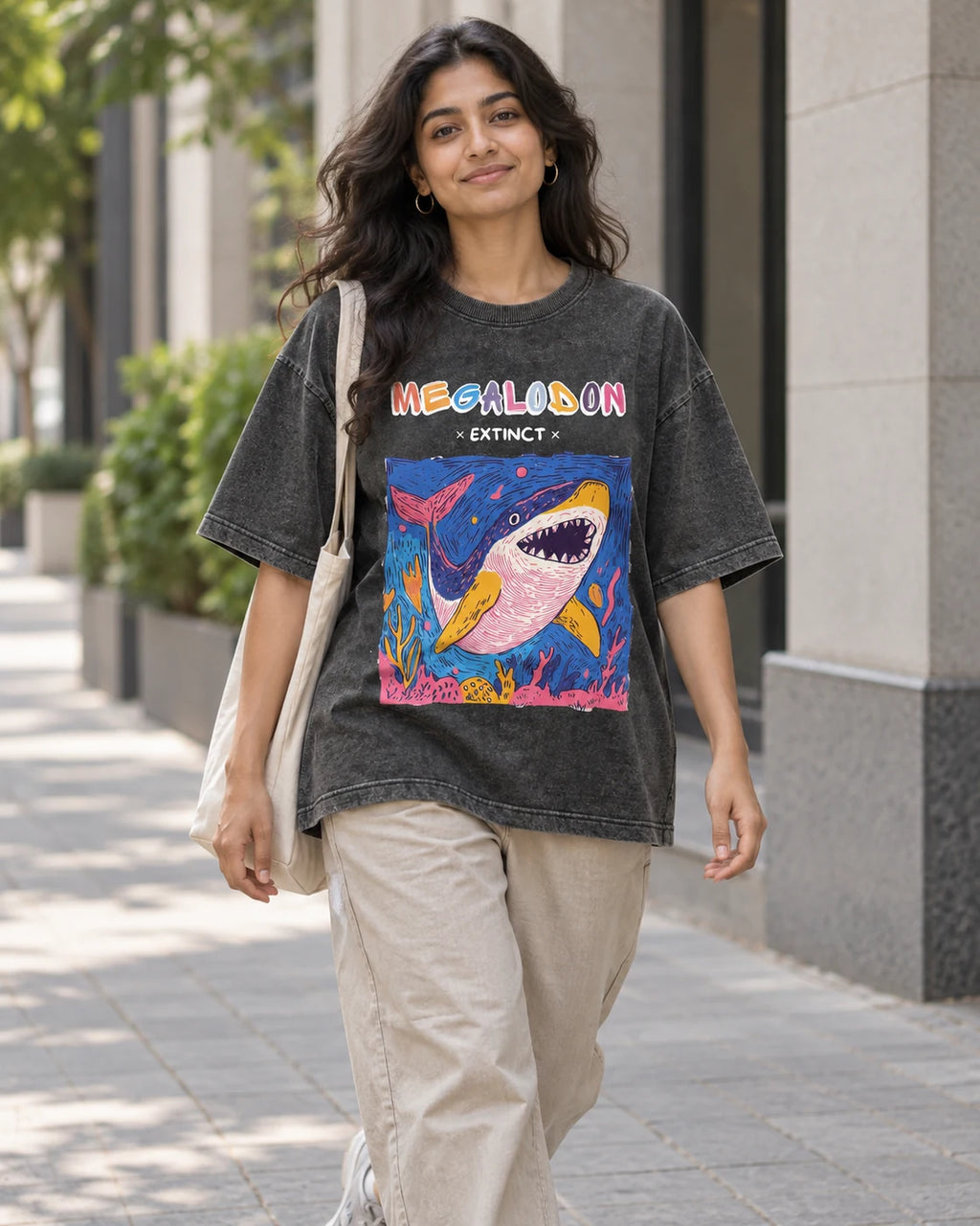 Model wearing the Megalodon black acid wash oversized T-shirt on a city street, Fourth Dimension Club