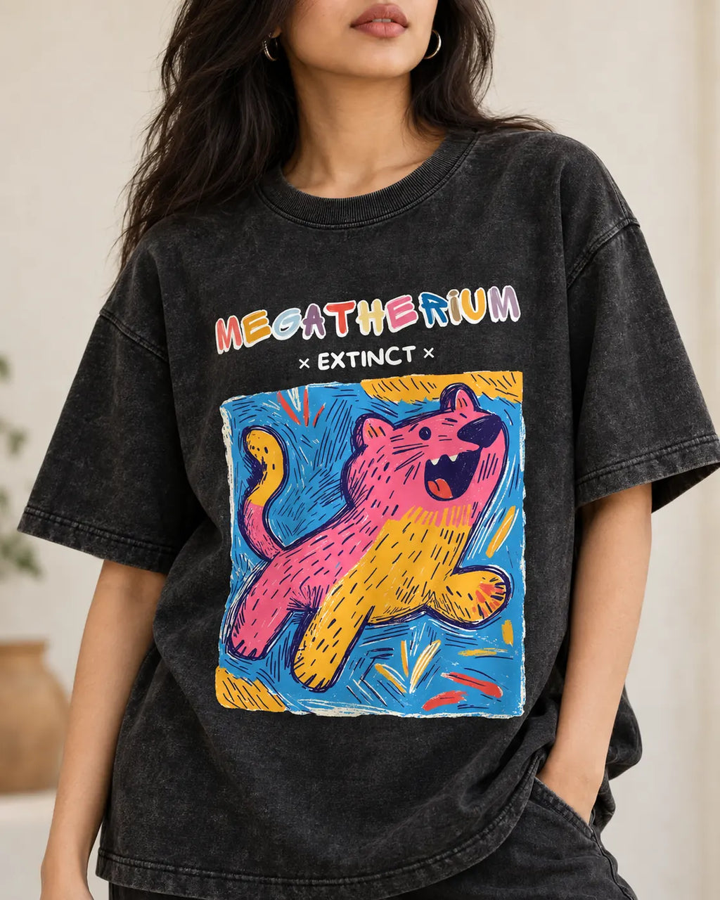 Close-up of the Megatherium Ancient Archives print on a black acid wash oversized T-shirt