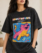 Close-up of the Megatherium Ancient Archives print on a black acid wash oversized T-shirt
