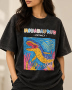 Close-up of the Mosasaurus Ancient Archives print on a black acid wash oversized T-shirt