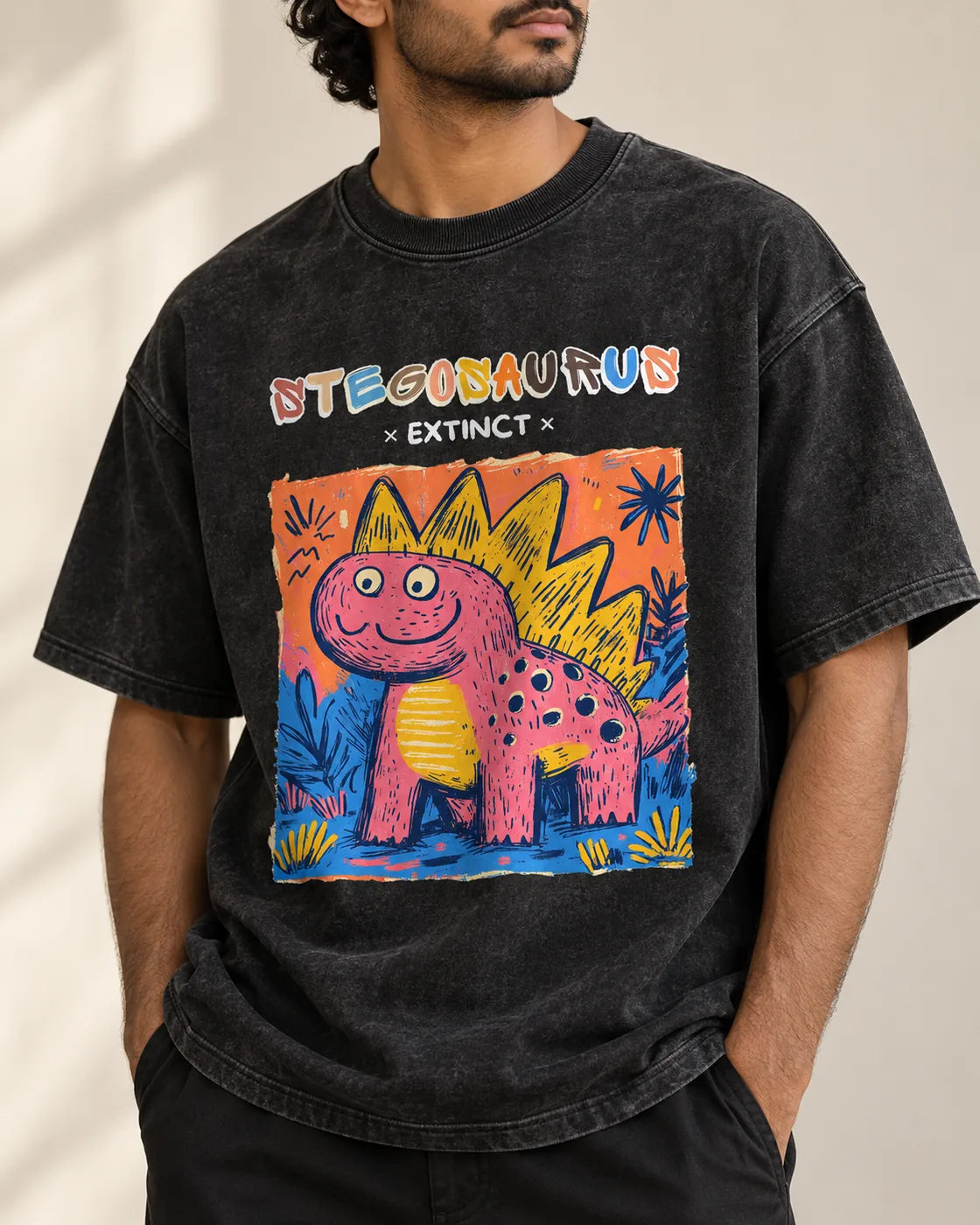 Close-up of the Stegosaurus Ancient Archives print on a black acid wash oversized T-shirt