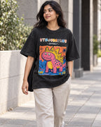 Model wearing the Stegosaurus black acid wash oversized T-shirt on a city street, Fourth Dimension Club