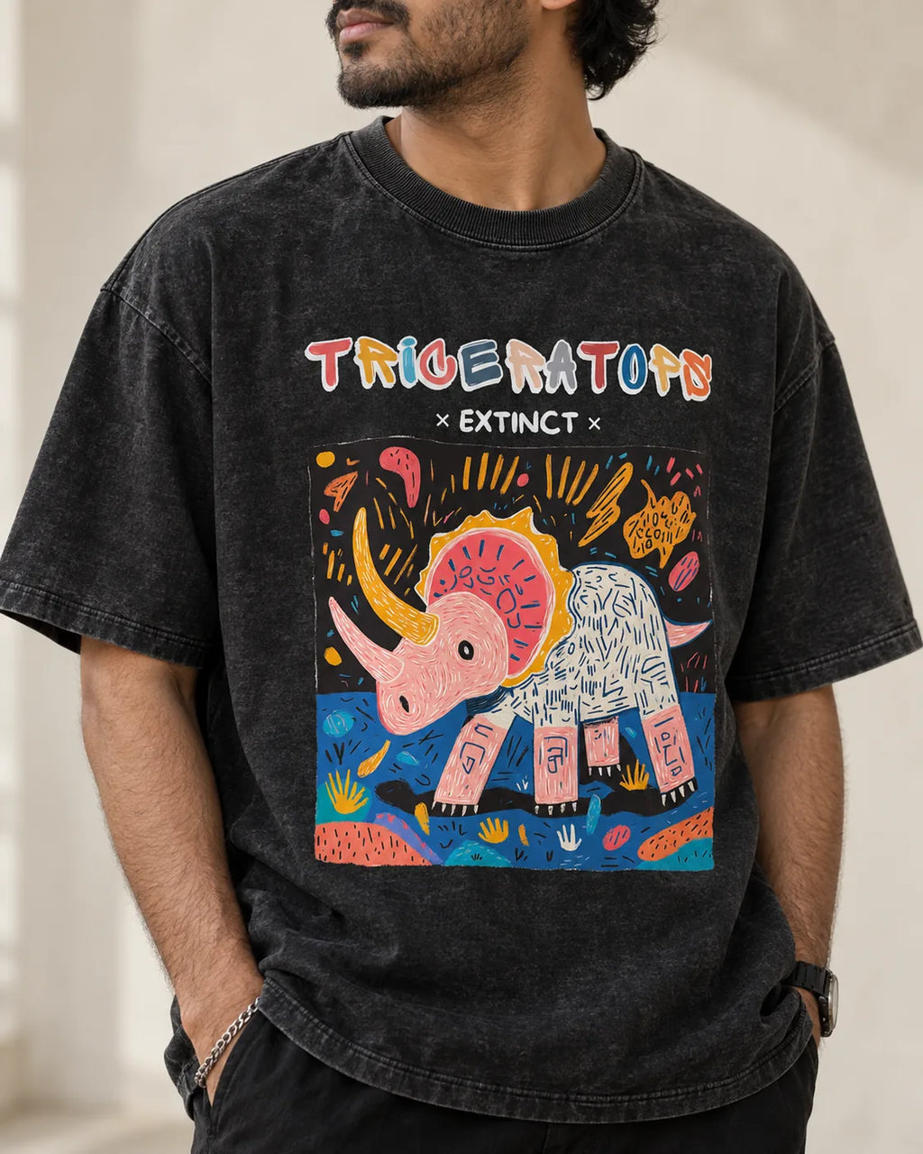 Close-up of the Triceratops Ancient Archives print on a black acid wash oversized T-shirt
