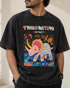 Close-up of the Triceratops Ancient Archives print on a black acid wash oversized T-shirt
