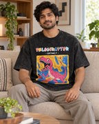 Model wearing the Velociraptor black acid wash oversized T-shirt seated on a sofa, Fourth Dimension Club