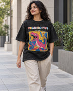 Model wearing the Velociraptor black acid wash oversized T-shirt on a city street, Fourth Dimension Club