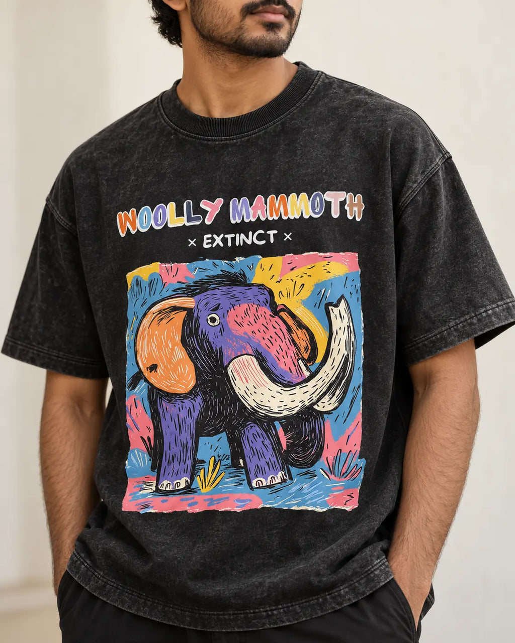 Close-up of the Woolly Mammoth Ancient Archives print on a black acid wash oversized T-shirt