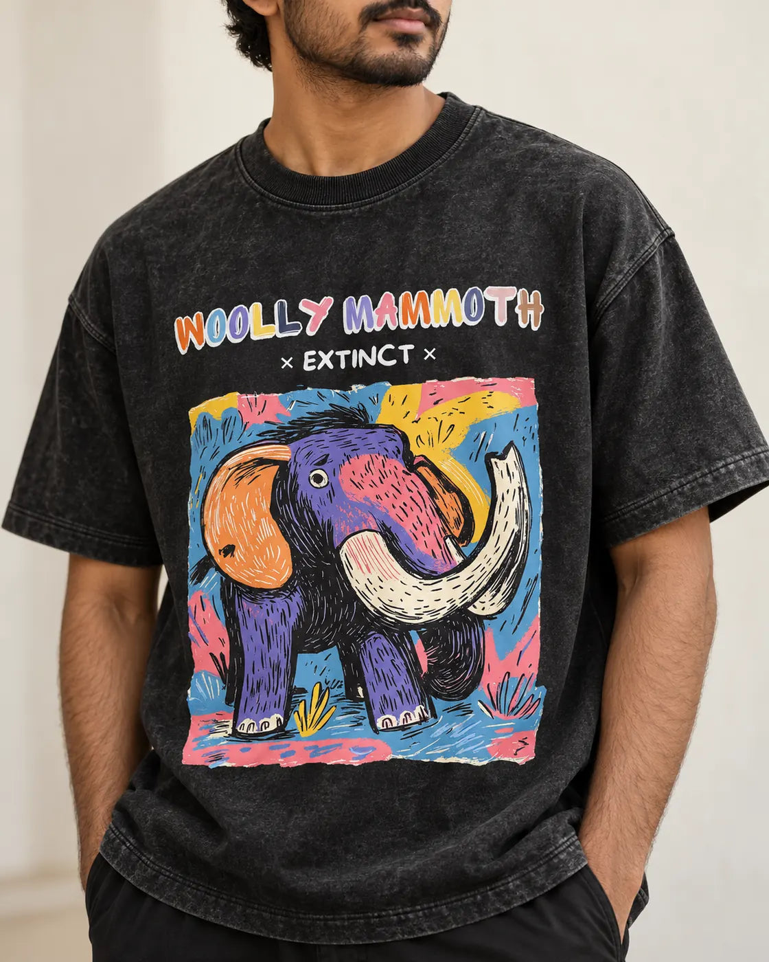Close-up of the Woolly Mammoth Ancient Archives print on a black acid wash oversized T-shirt