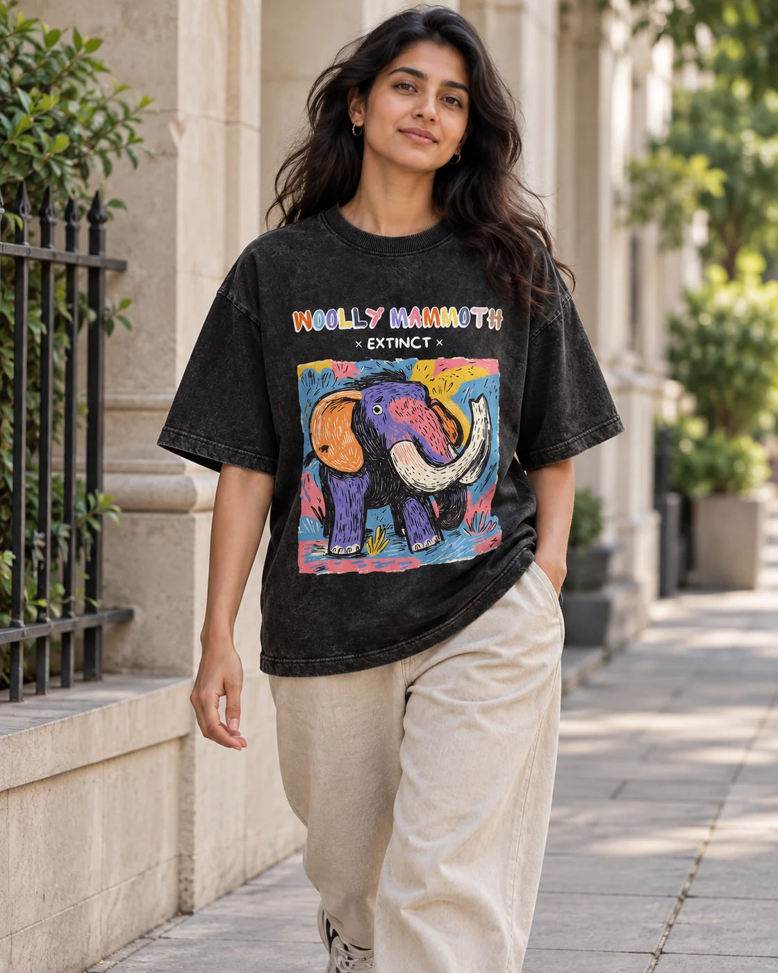 Model wearing the Woolly Mammoth black acid wash oversized T-shirt on a city street, Fourth Dimension Club