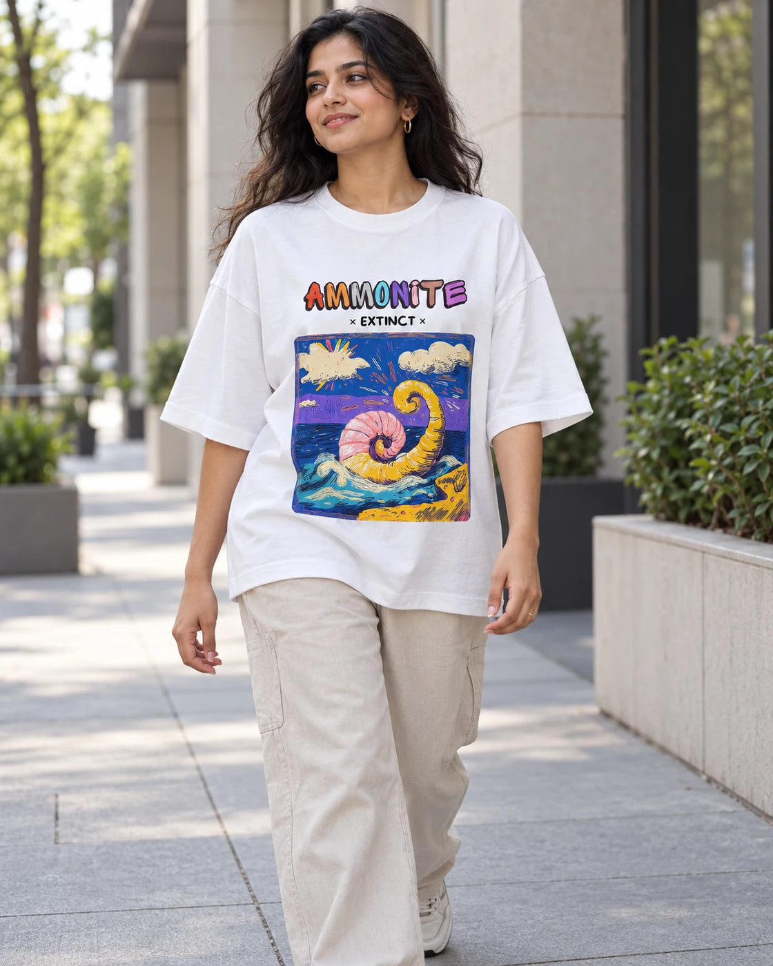 Model wearing the Ammonite white oversized French terry T-shirt on a city street, Fourth Dimension Club