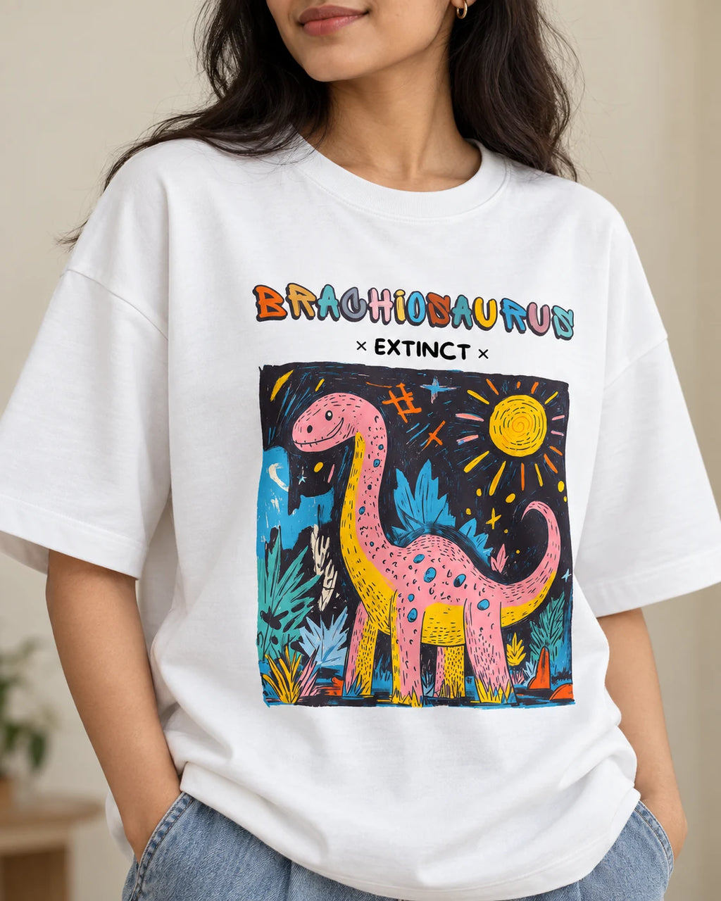 Close-up of the Brachiosaurus Ancient Archives print on a white oversized French terry T-shirt