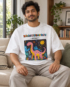 Model wearing the Brachiosaurus white oversized French terry T-shirt seated on a sofa, Fourth Dimension Club