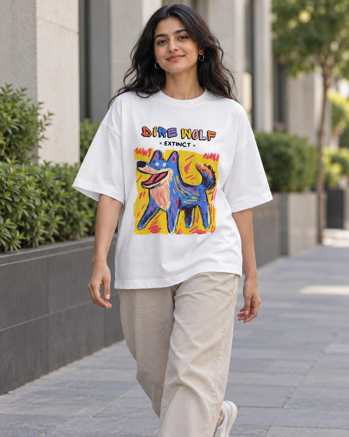 Model wearing the Dire Wolf white oversized French terry T-shirt on a city street, Fourth Dimension Club