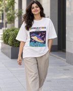 Model wearing the Dunkleosteus white oversized French terry T-shirt on a city street, Fourth Dimension Club