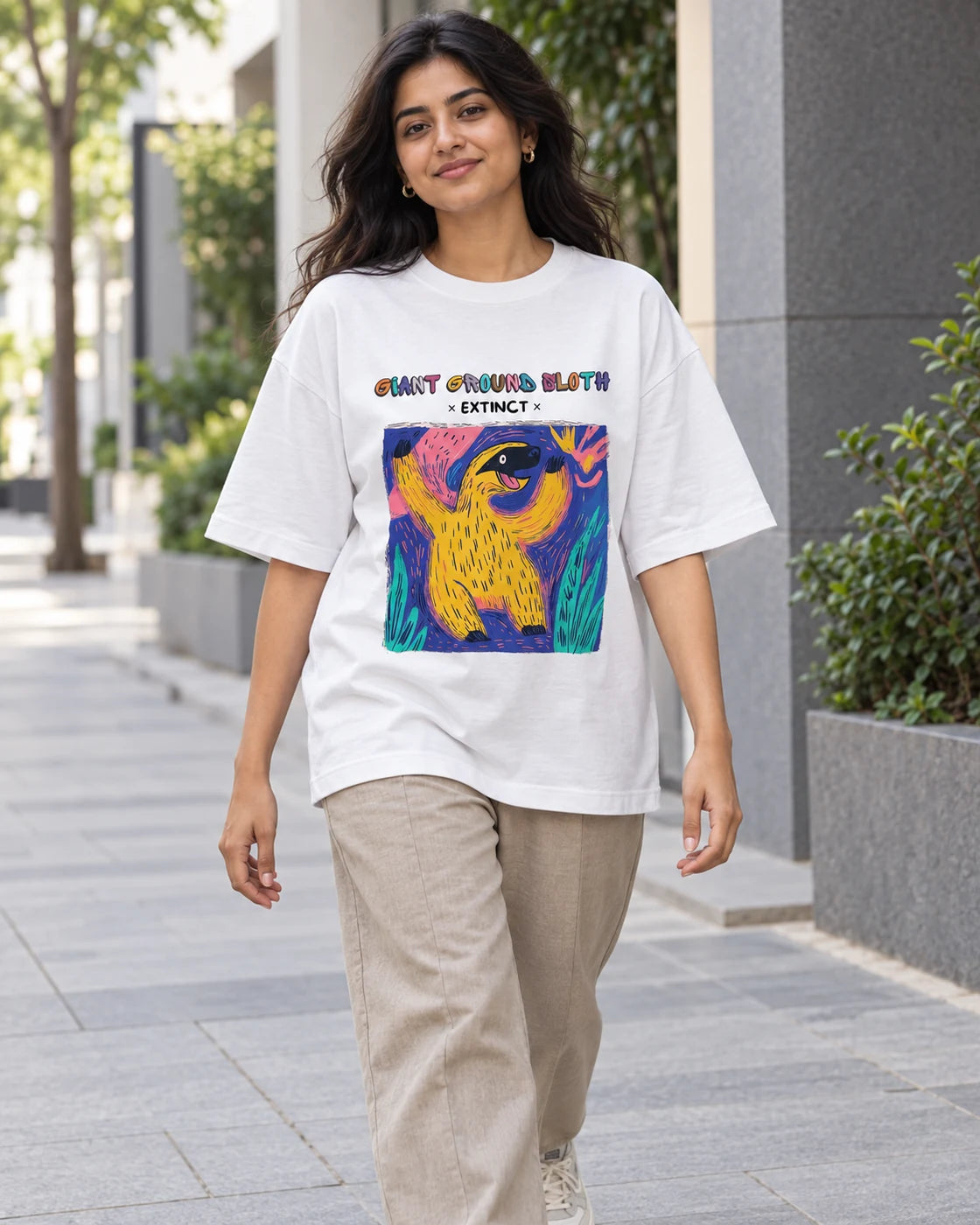 Model wearing the Giant Ground Sloth white oversized French terry T-shirt on a city street, Fourth Dimension Club
