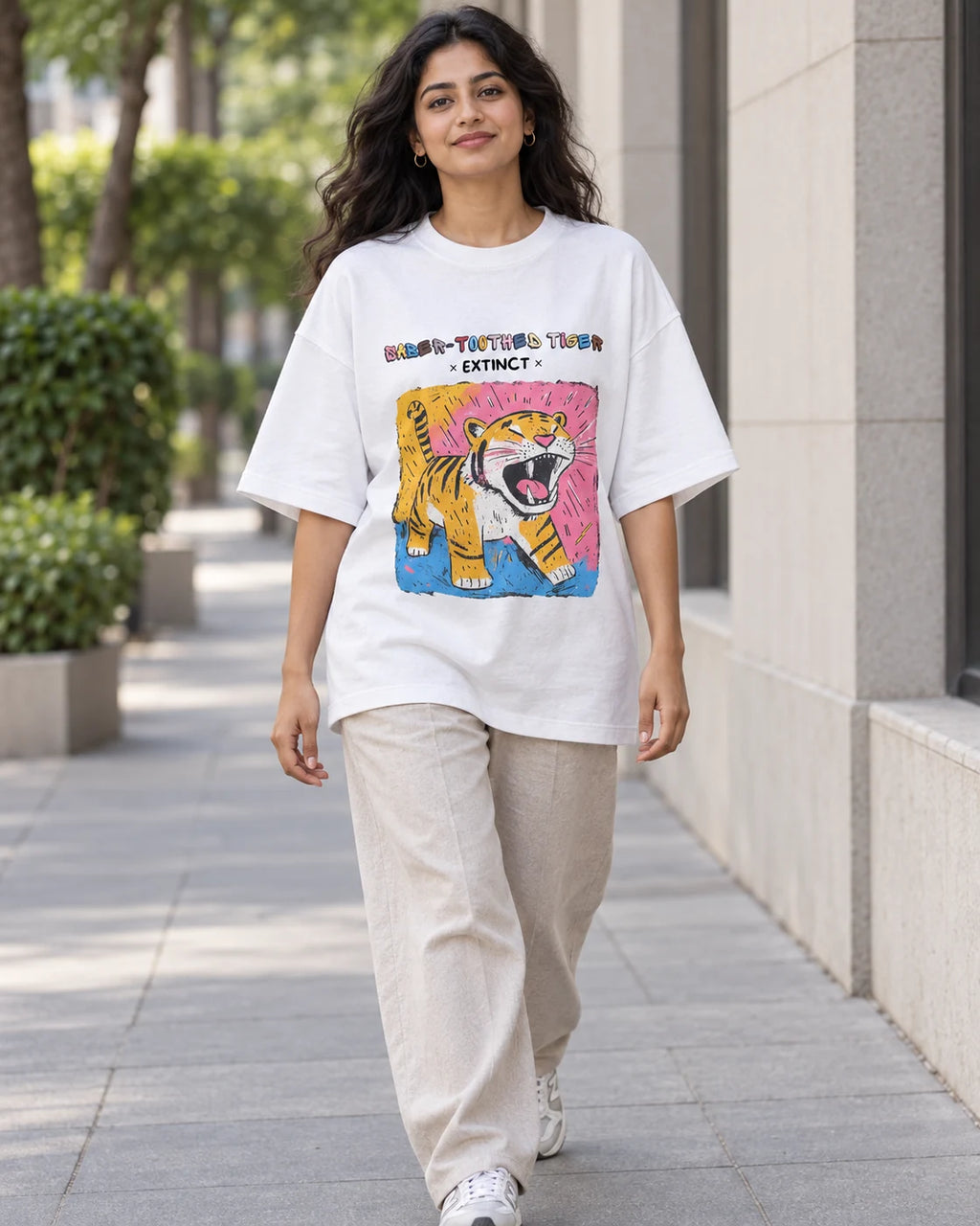 Model wearing the Saber-toothed Tiger white oversized French terry T-shirt on a city street, Fourth Dimension Club