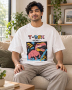 Model wearing the T-Rex white oversized French terry T-shirt seated on a sofa, Fourth Dimension Club