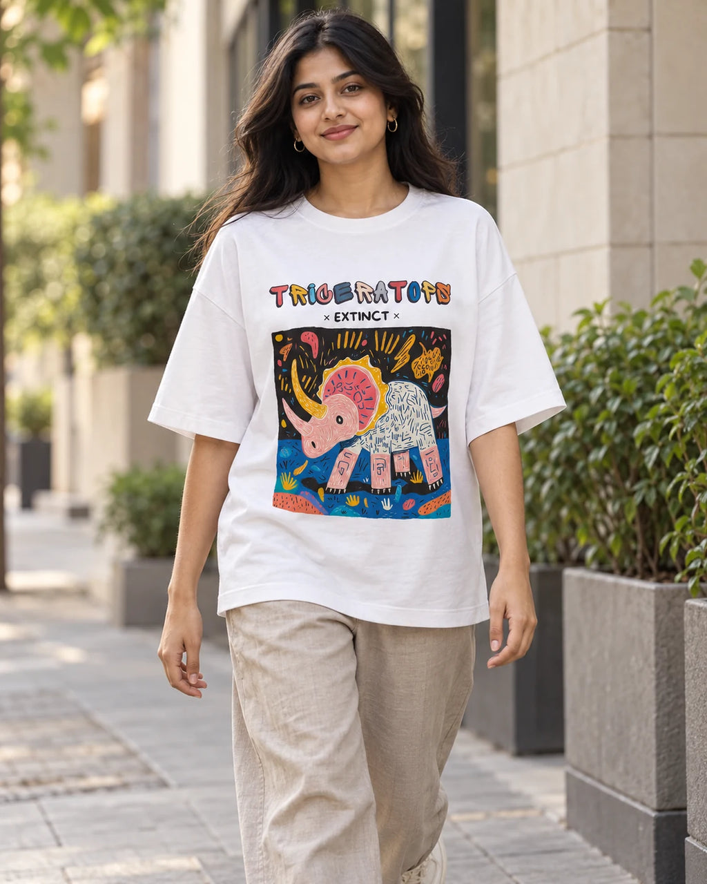Model wearing the Triceratops white oversized French terry T-shirt on a city street, Fourth Dimension Club
