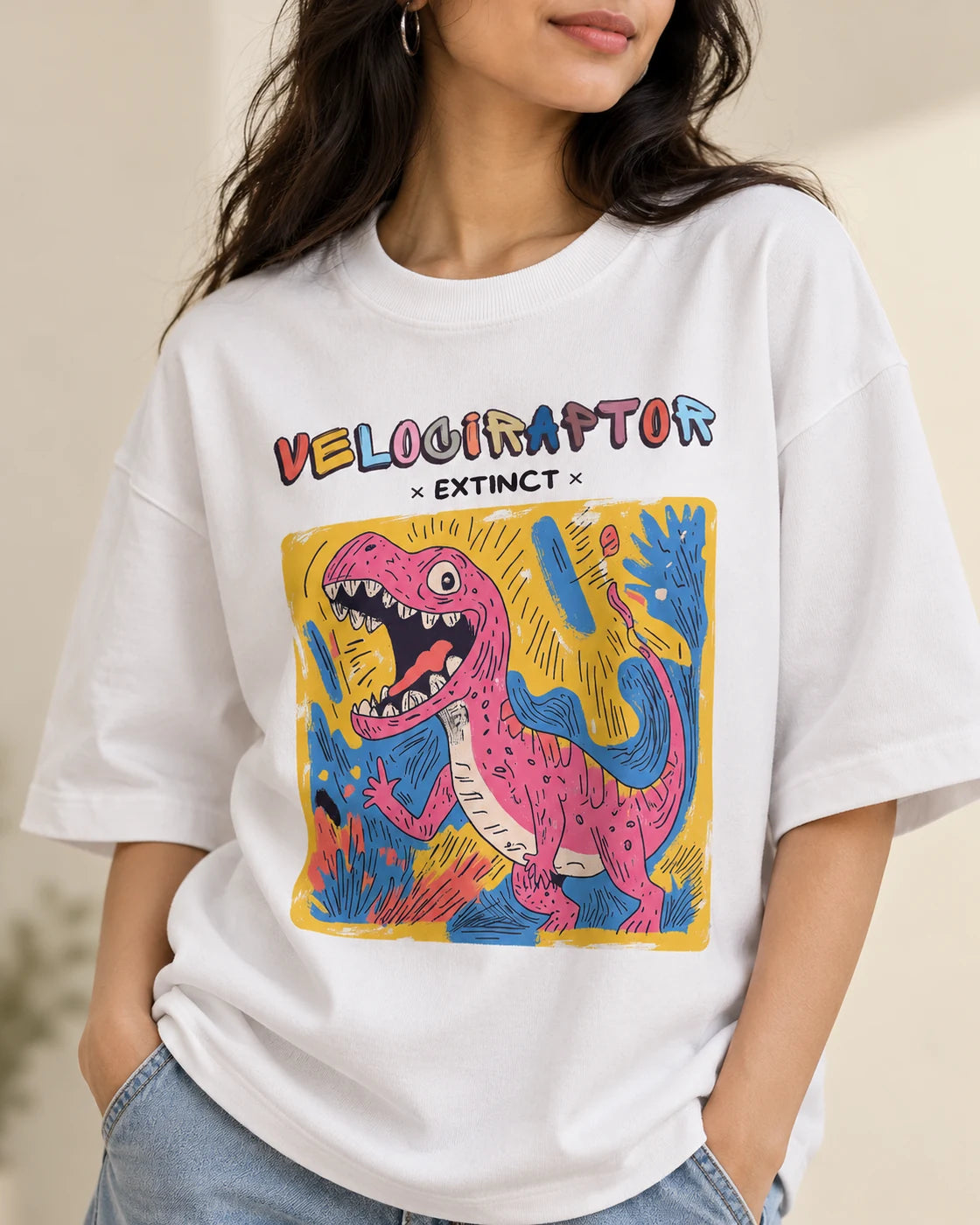 Close-up of the Velociraptor Ancient Archives print on a white oversized French terry T-shirt