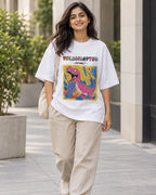 Model wearing the Velociraptor white oversized French terry T-shirt on a city street, Fourth Dimension Club